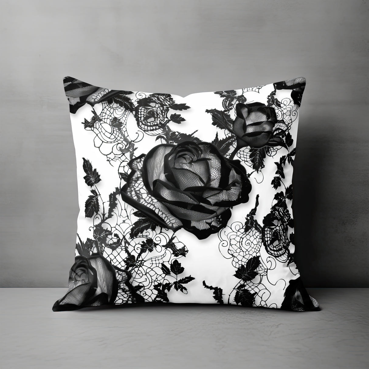 a black and white pillow with a rose on it