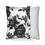 a black and white pillow with a flower on it