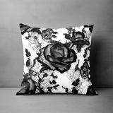 a black and white pillow with a rose on it